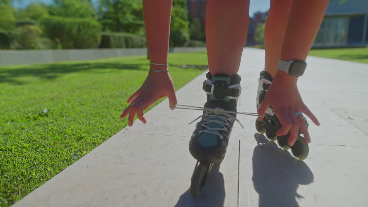 Woman Lacing Roller Skates Outdoors