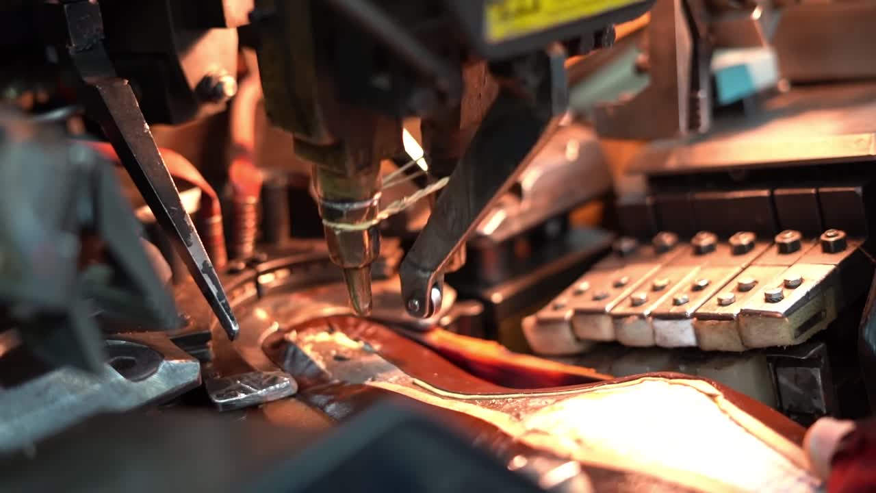 a craftsman handmade a shoe by a machine, close up shot, insert shot