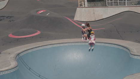 mother with children in outdoor skating arena