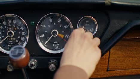 person adjusting car gauges