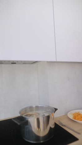 person cooking soup in modern kitchen