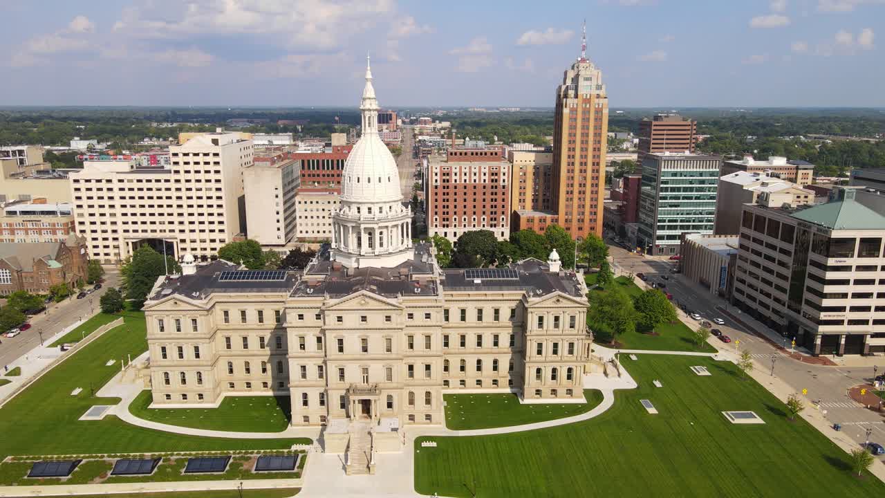 Panning aerial view of historic Michigan State Capitol Building in downtown Lansing