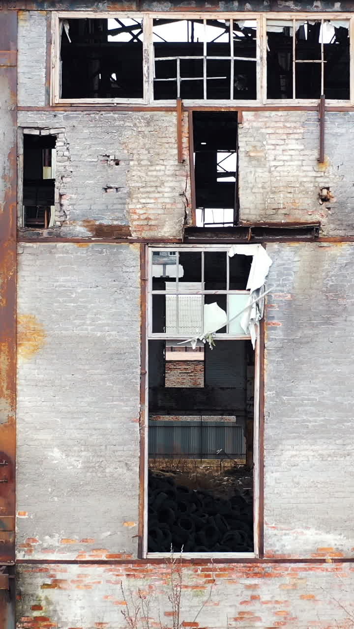 Ruins of an old factory. Old industrial building for demolition. Aerial view Vertical video