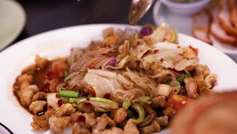 delicious thai dish being mixed and served