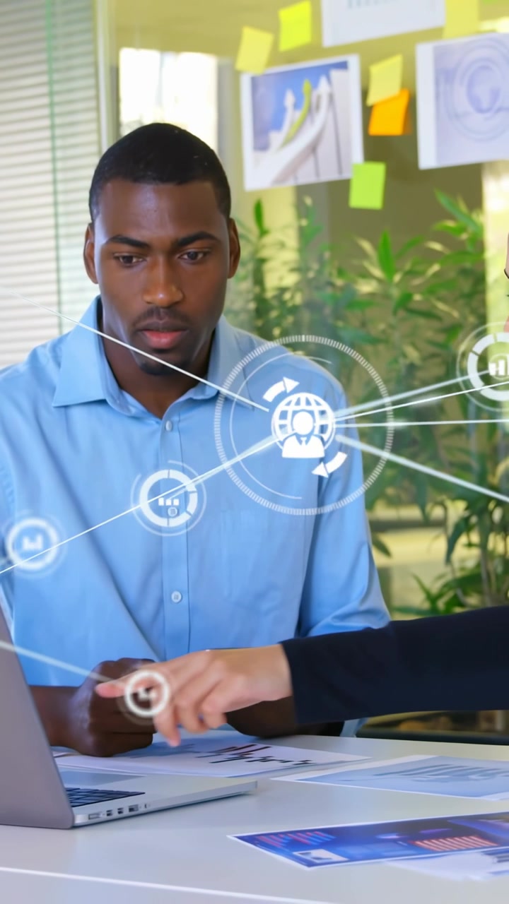 Vertical video: Woman pointing laptop starting network overlay, man holding tablet reviewing docs
