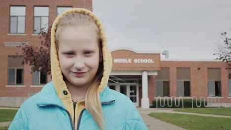Portrait-of-a-student-on-the-background-of-a-middle-school-building-in-the-United-States