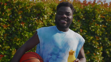 man with basketball and water bottle