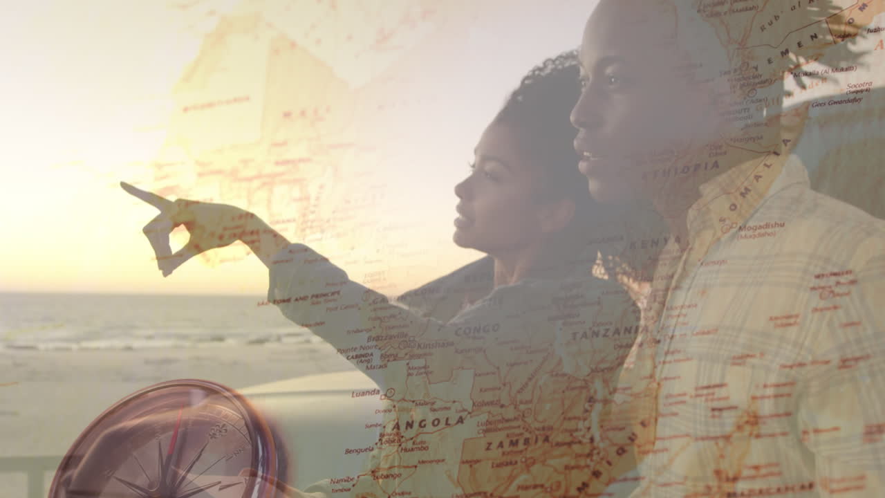 animación de una feliz pareja afroamericana disfrutando de la vista del atardecer en la playa sobre el mapa del mundo