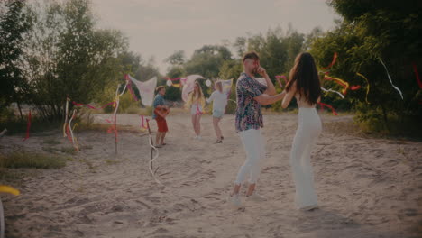 Pareja-Joven-Bailando-Bachata-Cerca-De-Amigos-Disfrutando-De-La-Fiesta-De-Verano