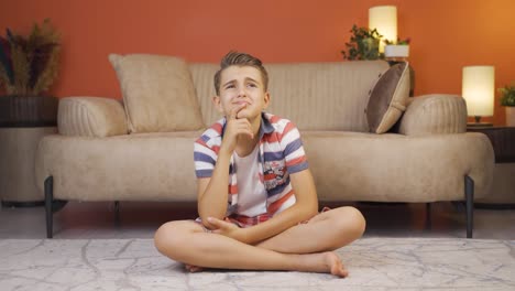 emotional boy thinking alone at home.
