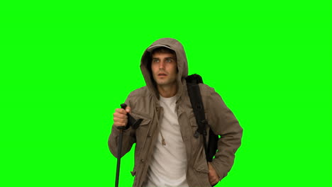 Man-with-a-coat-trekking-on-green-screen