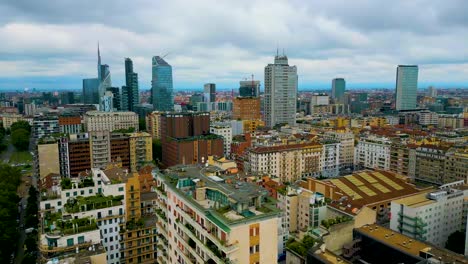 4k aerial drone video of rooftop patios on high rise apartment buildings in downtown milan, italy on a summer day
