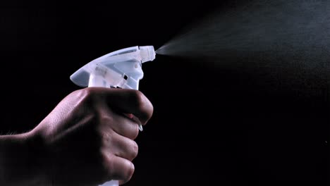 hand holding a spray bottle