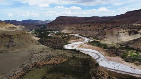 A-winding-road-through-a-valley-in-a-canyon,-bird's-eye-view,-slow-motion-over-Old-Paria-canyon-in-Kanab-Utah