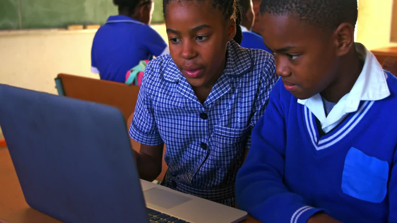 Schoolchildren using laptop in a lesson at a township school 4k