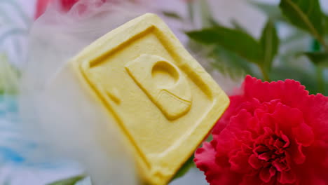 yellow block with smoke and flowers