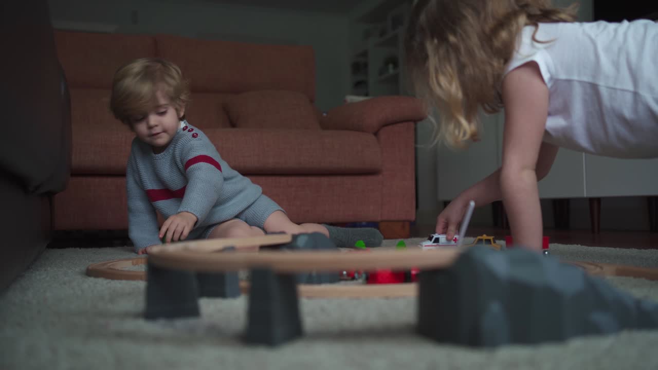 Kids playing with toy track game together
