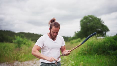 Male-Gardener-Sharpening-His-Sickle---medium-shot