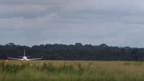 wide shot of a plane taking off in slow motion