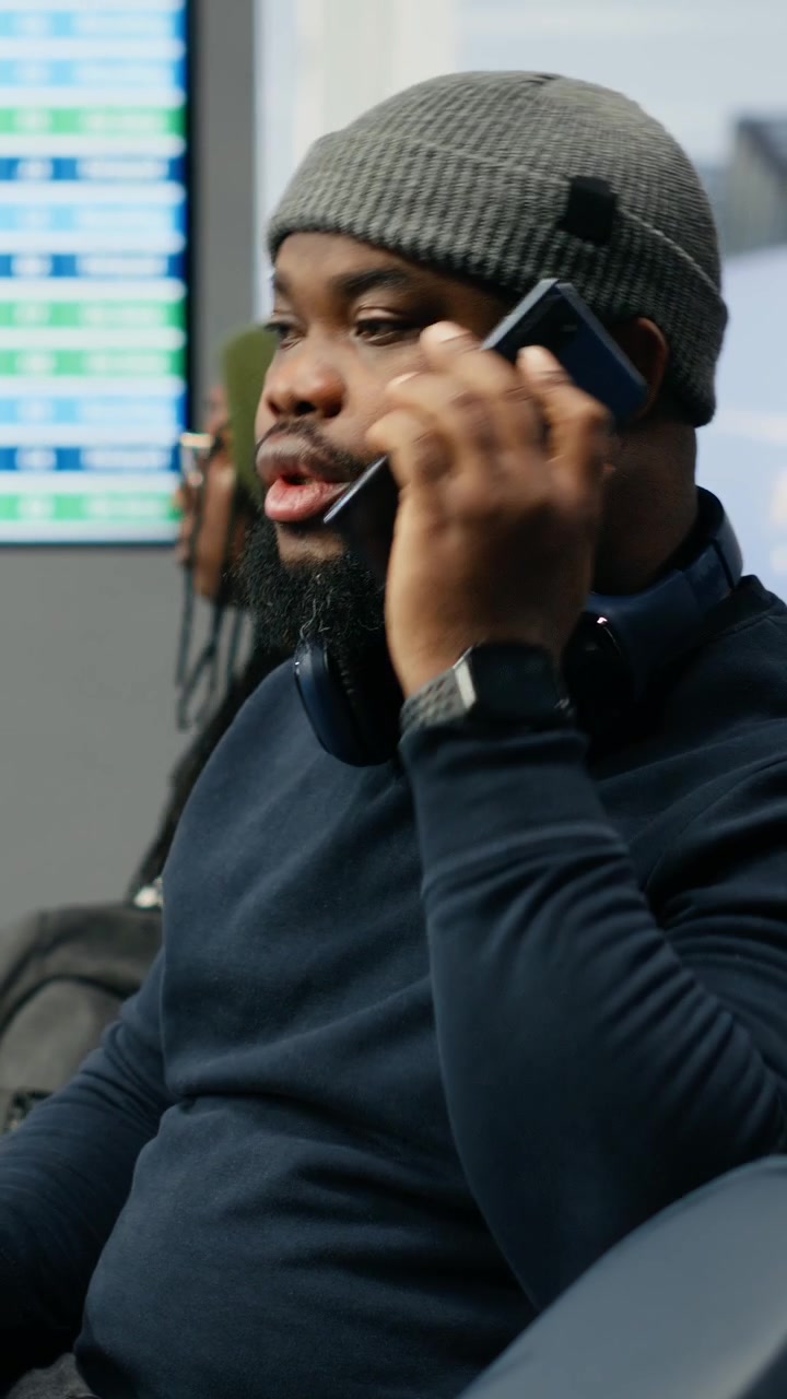 Vertical Video African american manager in casual outfit chatting on phone call in airport