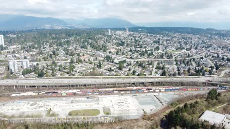 Drone-Footage-of-a-suburb-on-a-hill-highway---mid-day