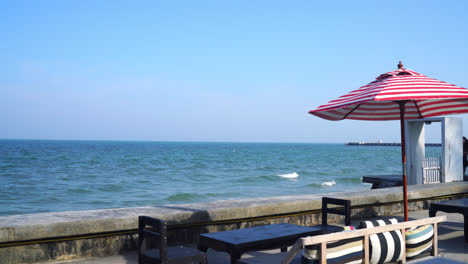 empty bench sofa with umbrella and ocean sea background - holiday and vacation concept