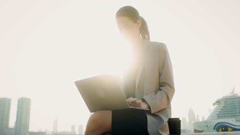 businesswoman working outdoors with laptop