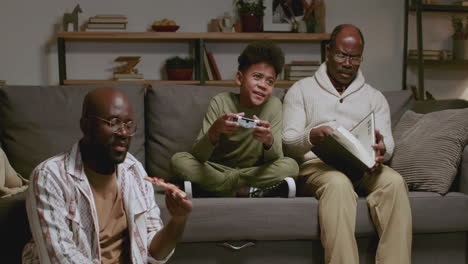 Black-men-and-boy-in-the-living-room-at-night