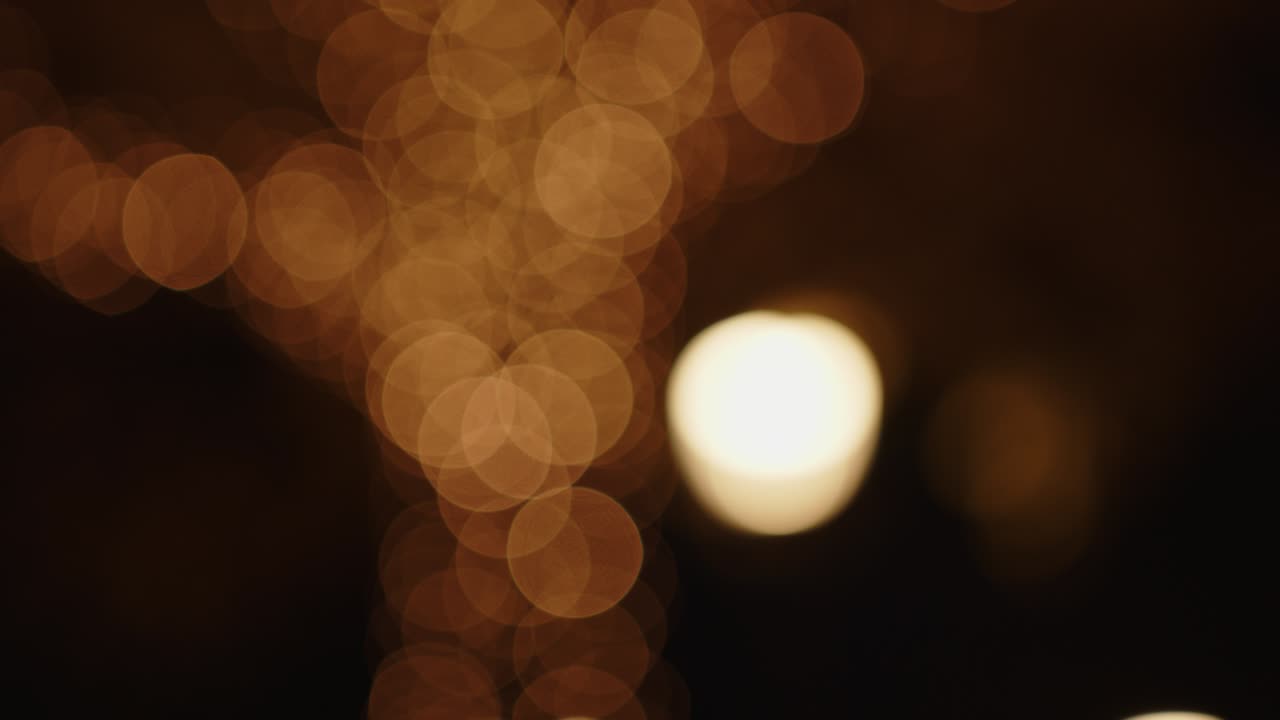 la luz de la calle y las luces navideñas pasan de estar desenfocadas con un hermoso bokeh a estar enfocadas con hojas de otoño