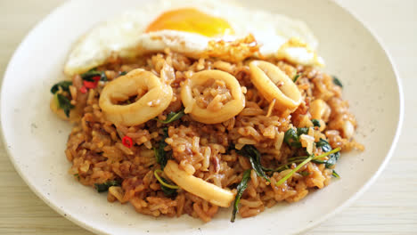 fried rice with squid and basil topped fried egg in thai style - asian food style
