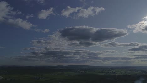 white and dark fluffy clouds with a blue sky