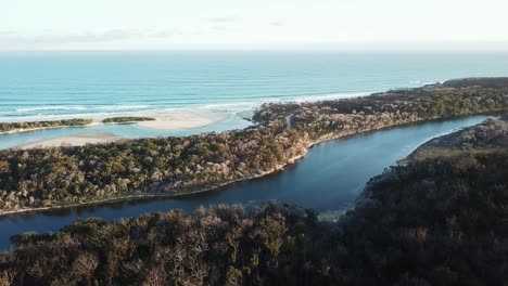 aerial footage in the late afternoon over the mouth of the betka river in eastern victoria, australia, december 2020