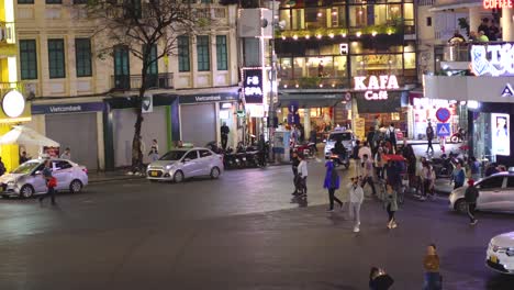 pedestrians and traffic at a busy city square