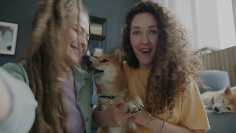 two women with a shiba inu dog taking a selfie