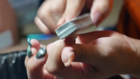 Woman-Doing-Her-Own-Manicure-By-Using-Nail-File-and-other-Equipments