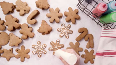 decorating gingerbread cookies with royal icing for christmas.