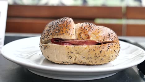 a close up of a poppy seed roll sandwich