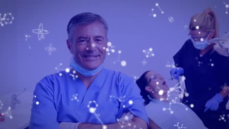 Slow-motion-animation-of-molecular-structures-with-confident-male-dentist,-nurse-examining-patient