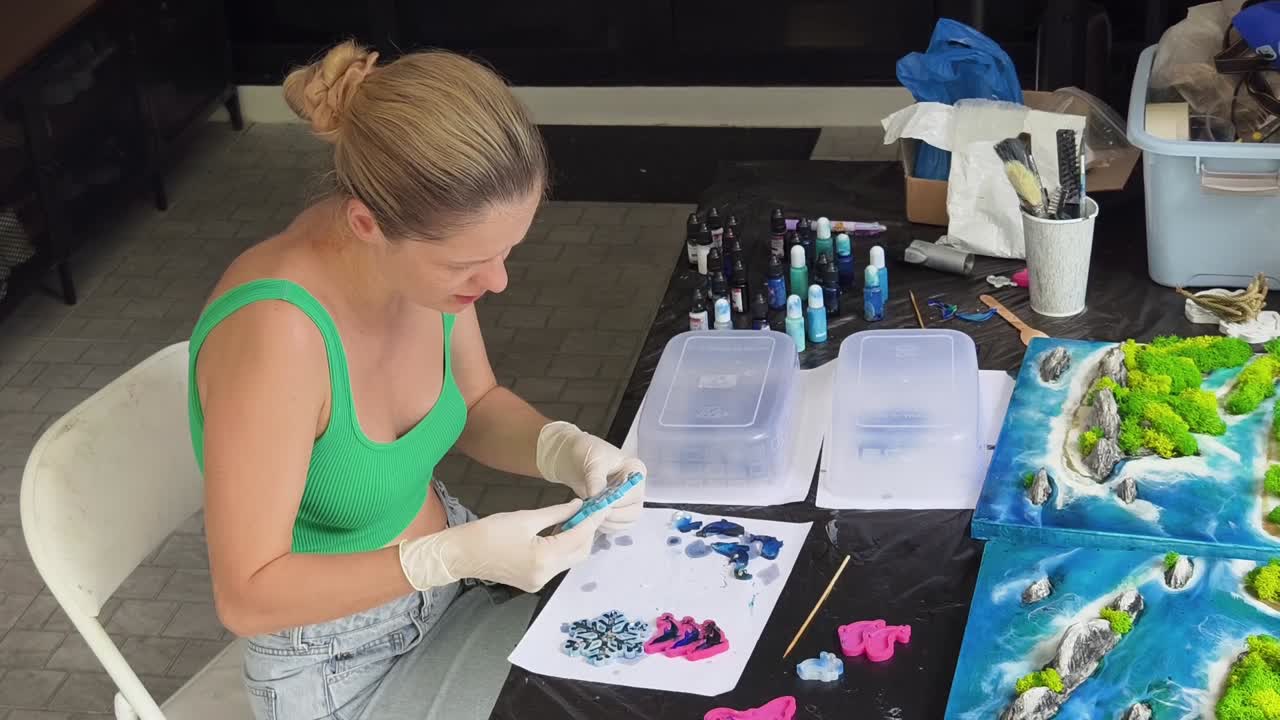 Mulher criando paisagens em miniatura de resina