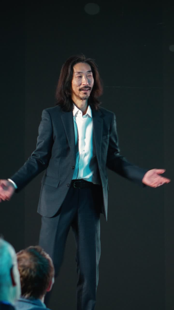 Vertical Video Asian product manager revealing new smartphone launch at convention event