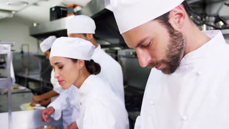 Team-of-chefs-chopping-vegetables-and-preparing-food