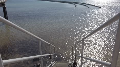 walking down stairs to the water at a swimming area in wallaroo south austrlai