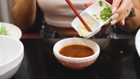 mixing ingredients into sauce with chopsticks