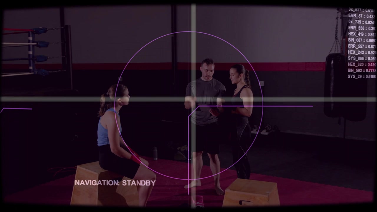 Trainer tapping tablet and briefing trainees on boxing drill, HUD reticle centering over group