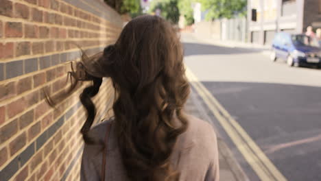 beautiful woman walking through urban city streets