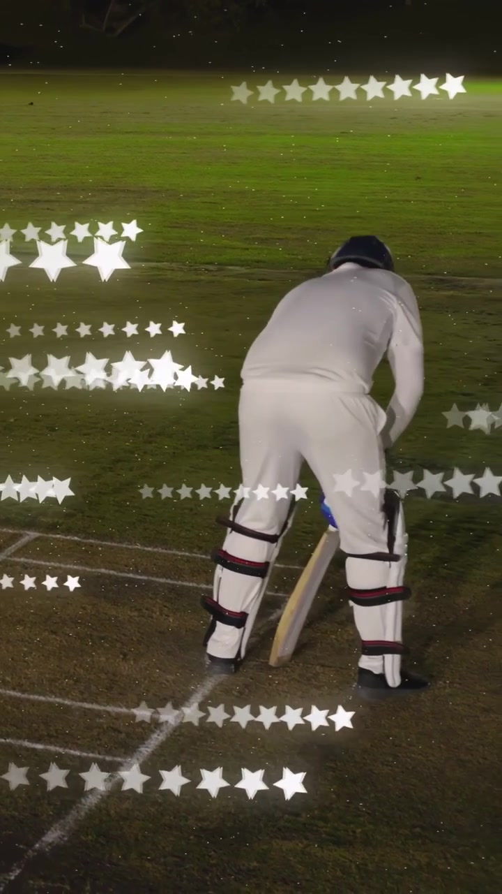 Video verticale: Battitore di cricket che batte la linea di battuta, aggiusta la posizione in attesa della palla, con sovrapposizione di stelle che si incrociano.