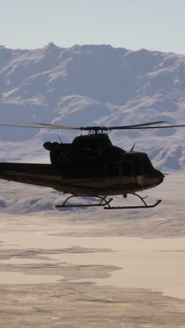 helicopter flying over a desert landscape