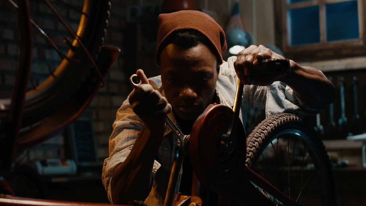 Man Repairing a Vintage Bicycle in a Garage