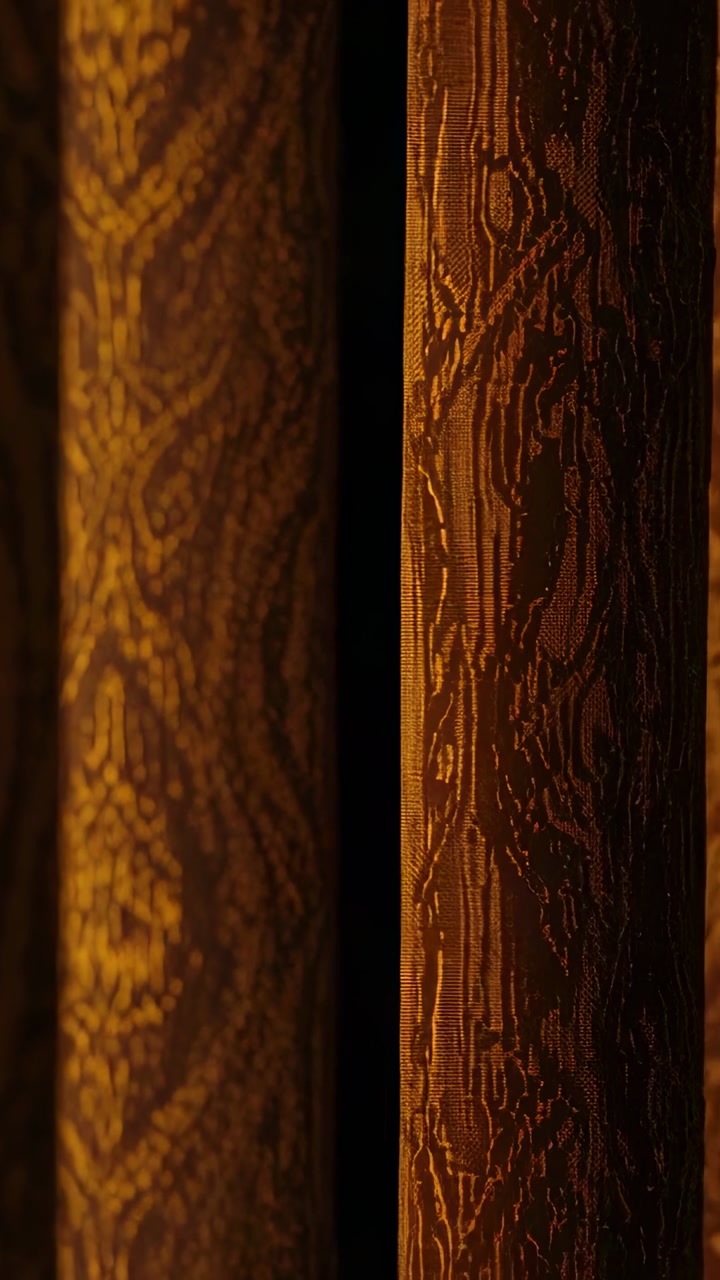 Ornate drapery panels moving, motor activating, widening woven gap under amber for interior design