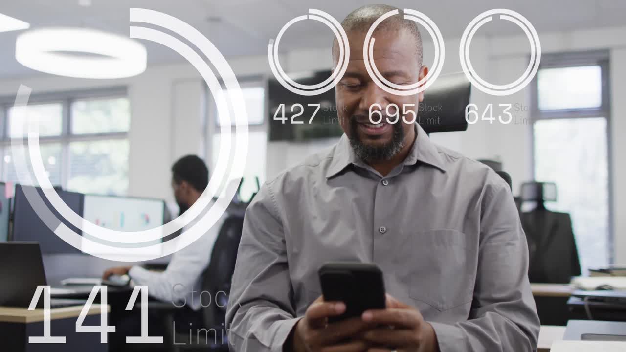 animación del procesamiento de datos sobre un hombre de negocios afroamericano usando un teléfono inteligente en la oficina.
